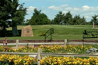 view of golf course with entrance sign